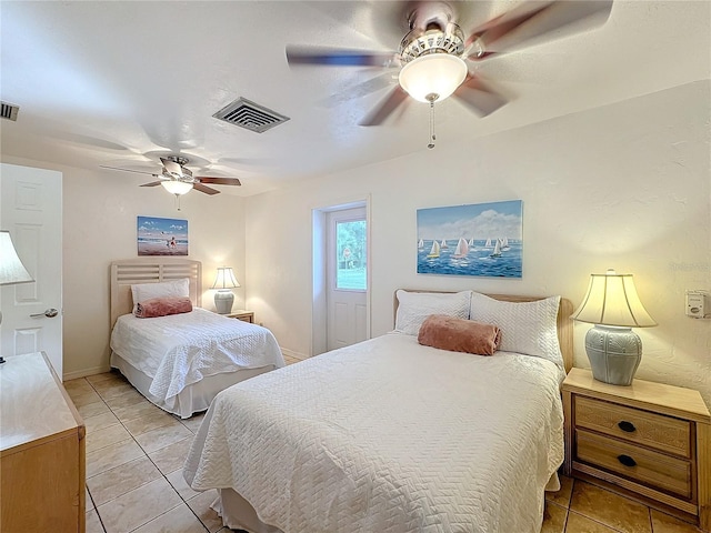 tiled bedroom featuring ceiling fan