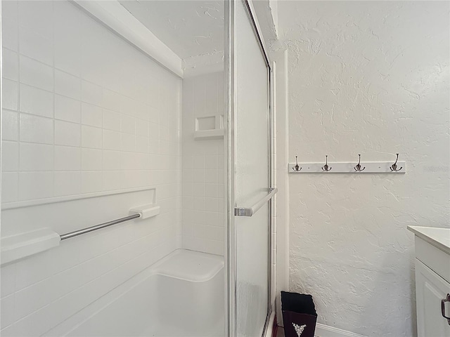 bathroom with vanity and a shower with shower door