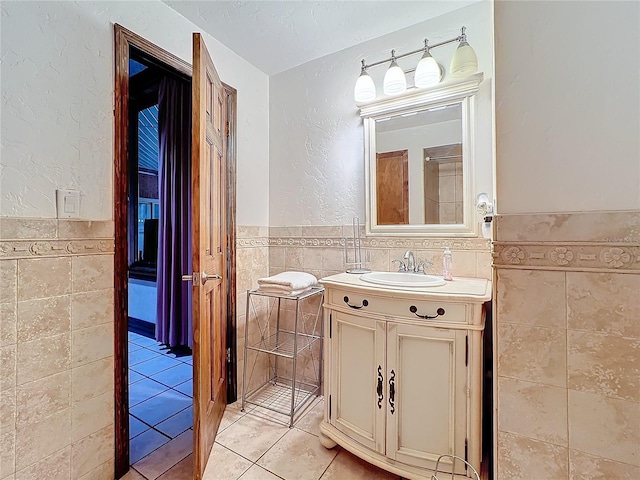 bathroom featuring vanity, tile walls, and tile patterned floors