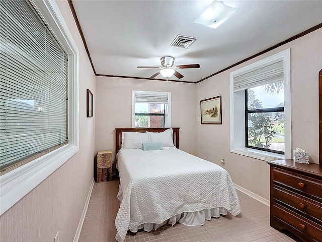 bedroom featuring ceiling fan and ornamental molding