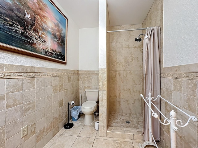 bathroom with tile patterned flooring, toilet, tile walls, and a shower with shower curtain