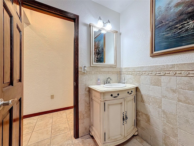 bathroom with vanity, tile patterned flooring, and tile walls