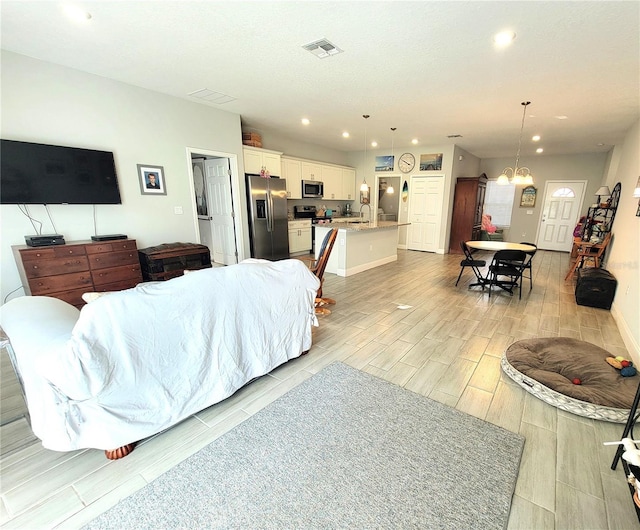 living room with sink and a chandelier