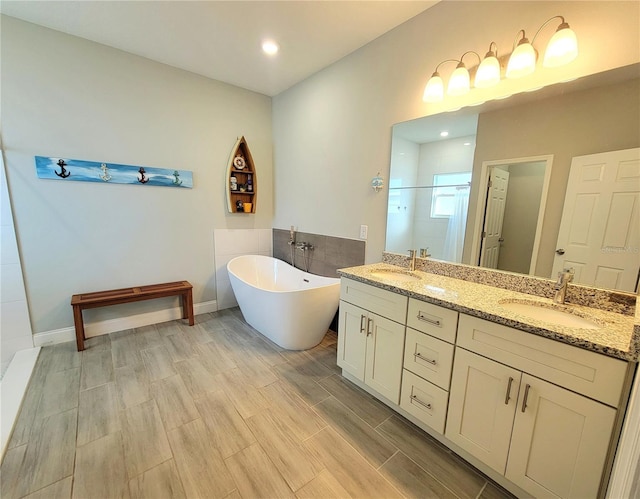 bathroom with vanity and independent shower and bath