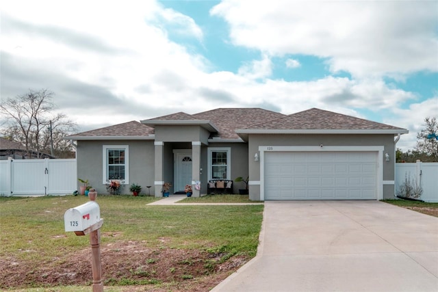 125 Inconnu Ct, Poinciana, FL 34759 - prairie-style house featuring a gate, stucco siding, driveway, a garage, and a shingled roof