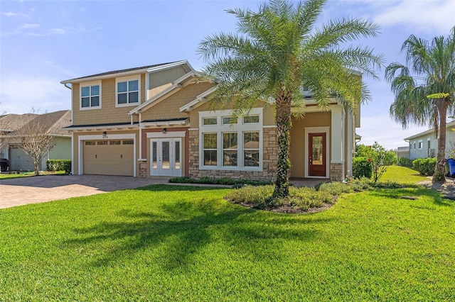 craftsman inspired home with stone siding, a front lawn, decorative driveway, and french doors