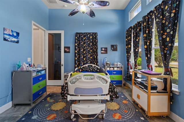 recreation room with a ceiling fan, visible vents, and baseboards