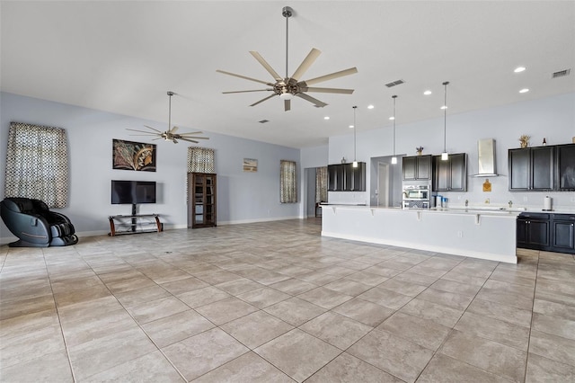 living room featuring light tile patterned floors, baseboards, visible vents, a ceiling fan, and recessed lighting