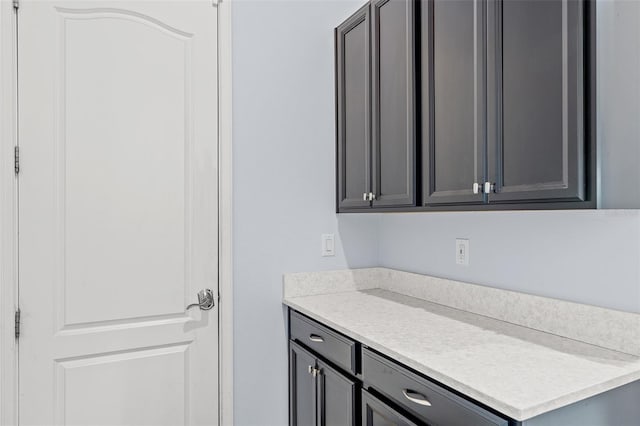 kitchen with light countertops and gray cabinetry