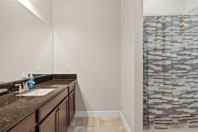 bathroom featuring tile patterned flooring, a shower with shower curtain, vanity, and baseboards