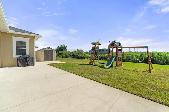 view of play area featuring an outbuilding, a patio area, a lawn, and a storage shed