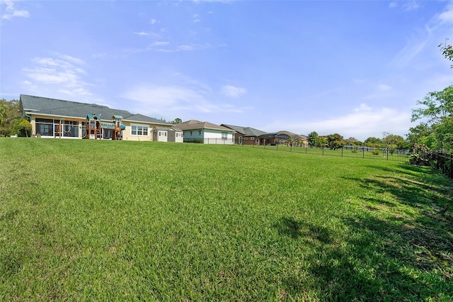 view of yard with fence and a playground