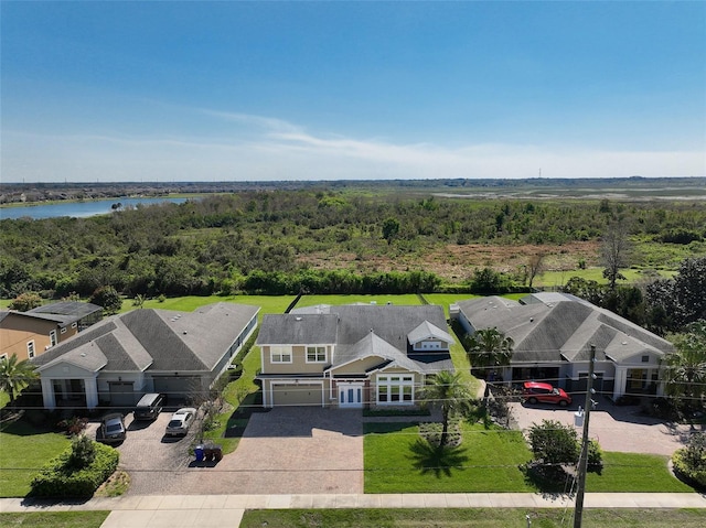 aerial view with a water view and a wooded view