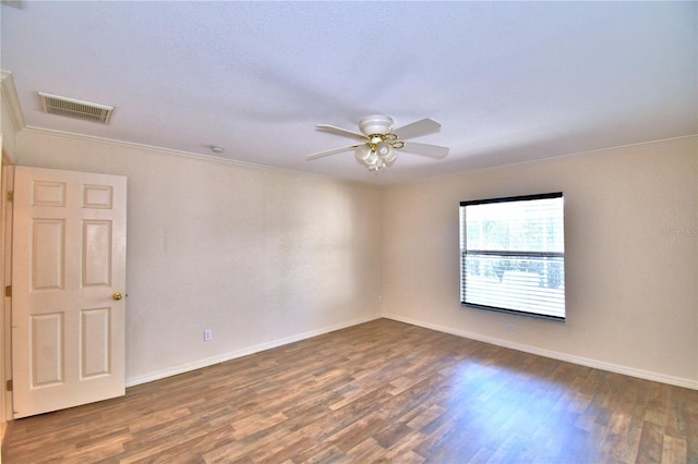 unfurnished room featuring crown molding, dark hardwood / wood-style floors, and ceiling fan