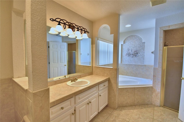 bathroom with shower with separate bathtub, tile patterned floors, and vanity