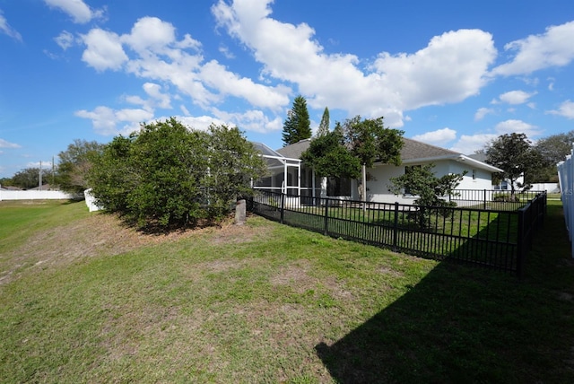 view of yard with glass enclosure