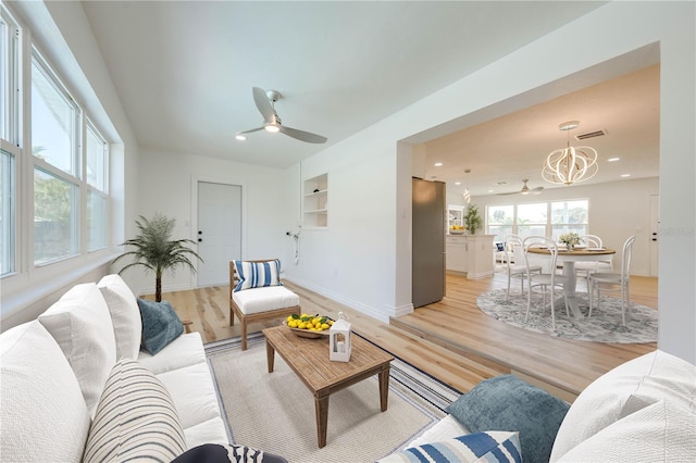 living room with light hardwood / wood-style flooring, ceiling fan, and plenty of natural light