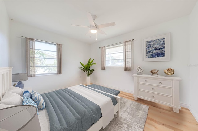 bedroom with ceiling fan and light hardwood / wood-style flooring