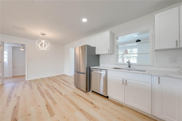 kitchen with white cabinetry, sink, light hardwood / wood-style flooring, and stainless steel appliances