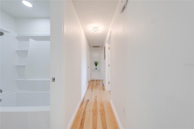 hall with light hardwood / wood-style floors