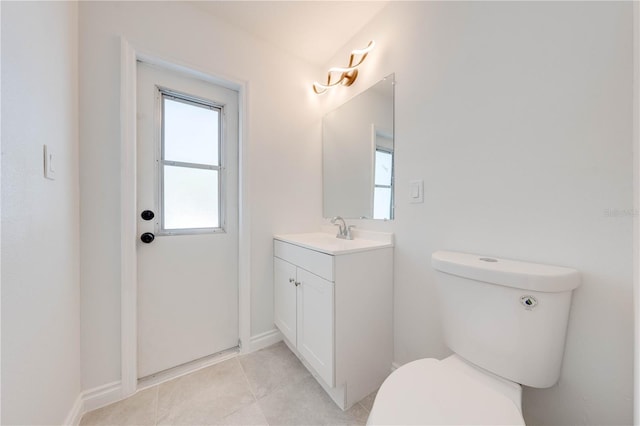 bathroom with tile patterned flooring, vanity, and toilet