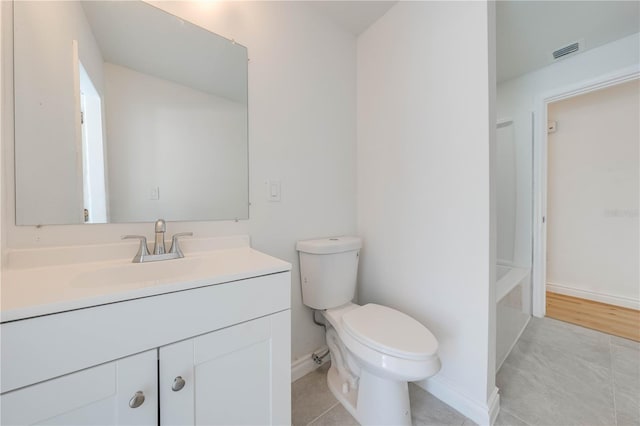 bathroom featuring tile patterned floors, vanity, and toilet