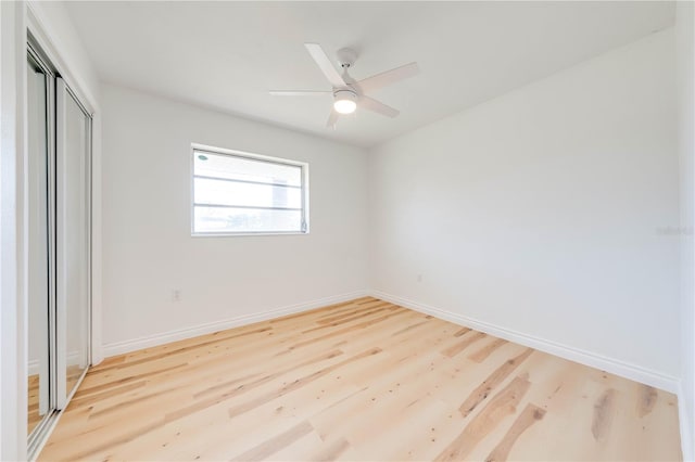 unfurnished bedroom with hardwood / wood-style flooring, ceiling fan, and a closet