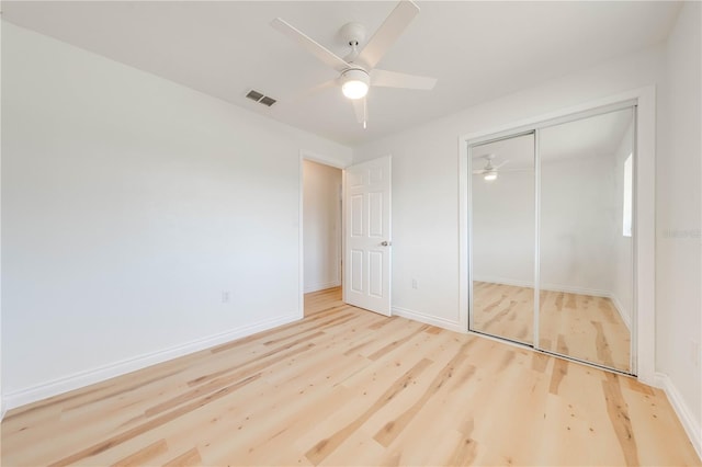 unfurnished bedroom featuring light hardwood / wood-style flooring, a closet, and ceiling fan