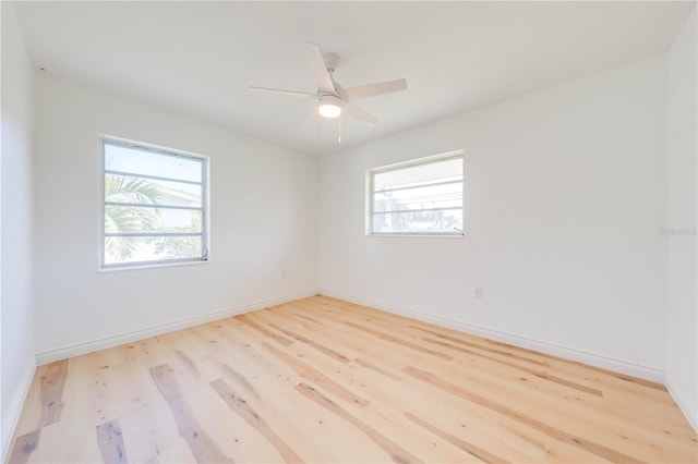 empty room with ceiling fan, a healthy amount of sunlight, and light wood-type flooring