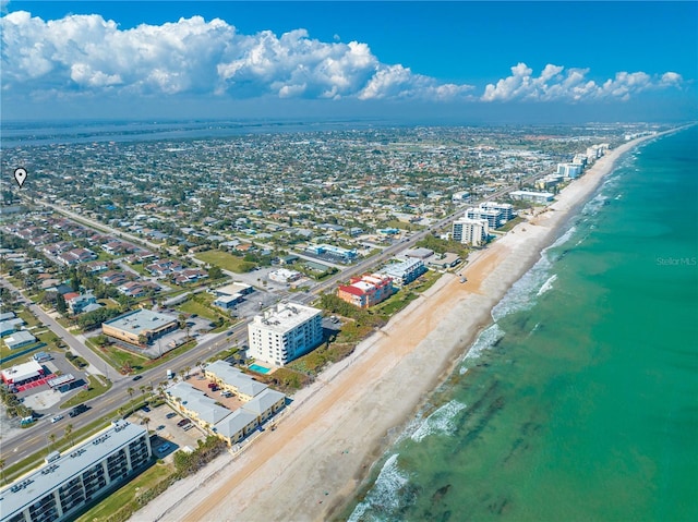 drone / aerial view featuring a beach view and a water view