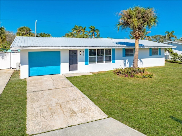 ranch-style home with a garage and a front lawn