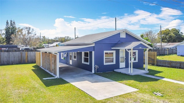 exterior space featuring a carport, a fenced backyard, and driveway