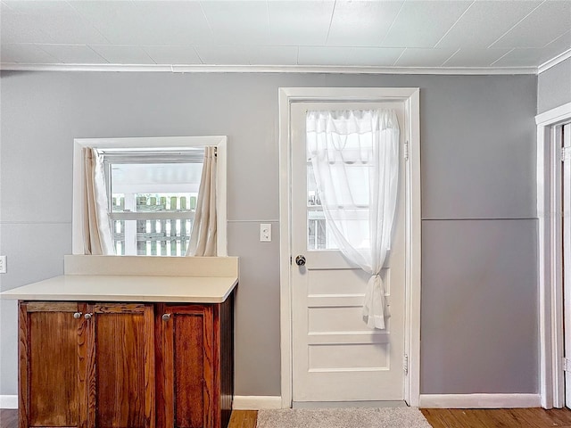 doorway featuring baseboards