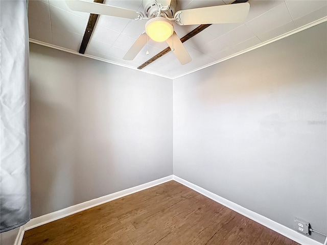 spare room with ceiling fan, baseboards, and wood finished floors