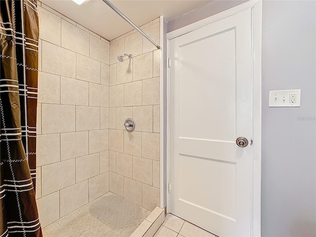 bathroom featuring tile patterned flooring and a shower stall