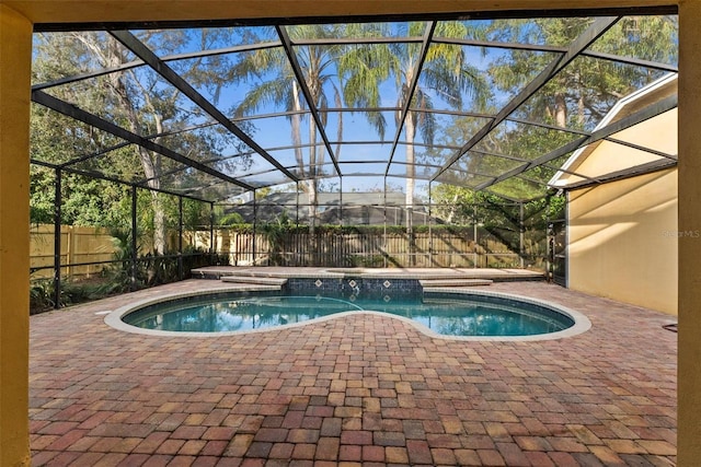 view of swimming pool with a lanai and a patio