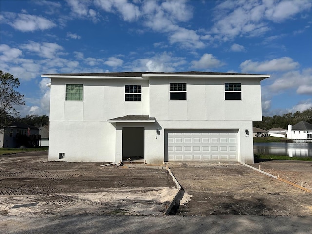 front of property featuring a water view and a garage