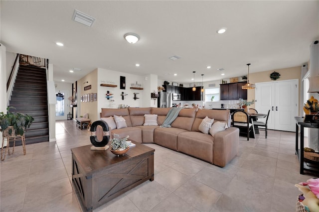 living room with a healthy amount of sunlight and light tile patterned floors