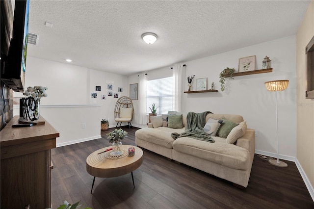 living room featuring dark hardwood / wood-style floors and a textured ceiling