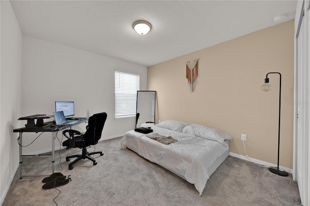 carpeted bedroom featuring a textured ceiling