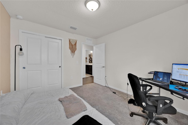 office with carpet floors and a textured ceiling