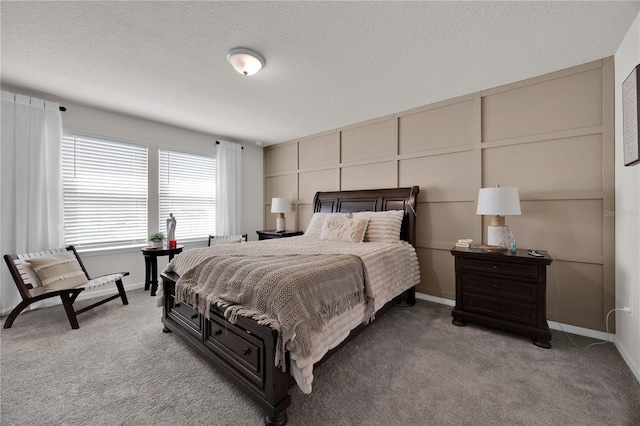 carpeted bedroom featuring a textured ceiling