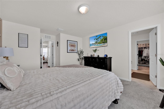 carpeted bedroom featuring a textured ceiling