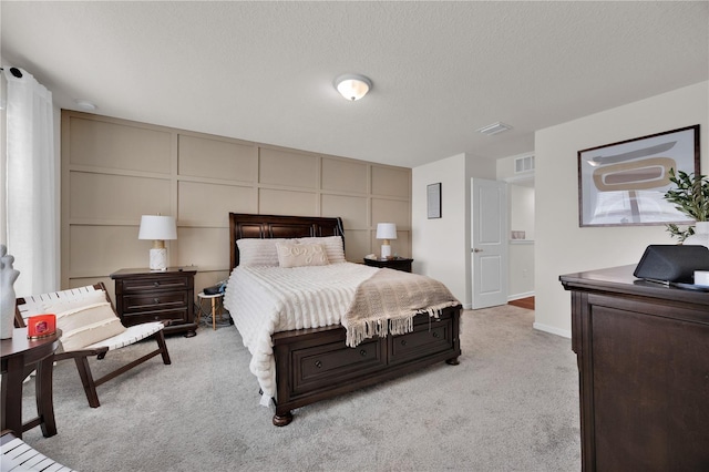 carpeted bedroom featuring a textured ceiling