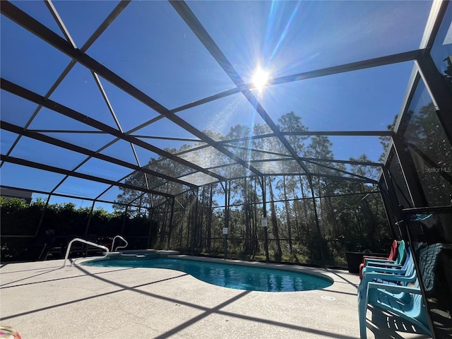 view of pool with a patio area, a lanai, and a pool with connected hot tub