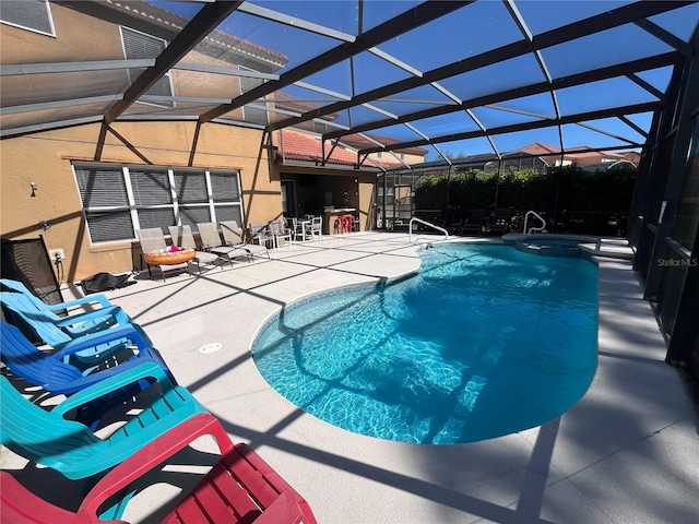 view of swimming pool with a pool with connected hot tub, a lanai, and a patio