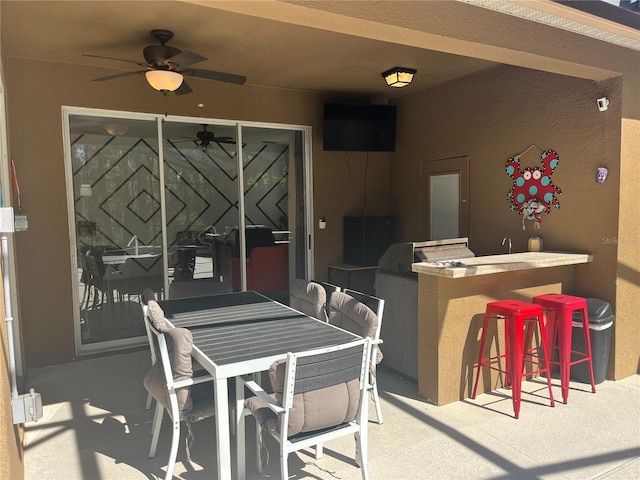 view of patio featuring ceiling fan and outdoor dry bar