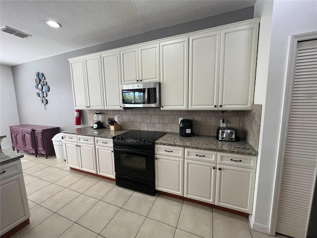 kitchen with black range with electric cooktop, stainless steel microwave, backsplash, and visible vents