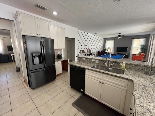 kitchen with visible vents, open floor plan, white cabinets, a sink, and black appliances