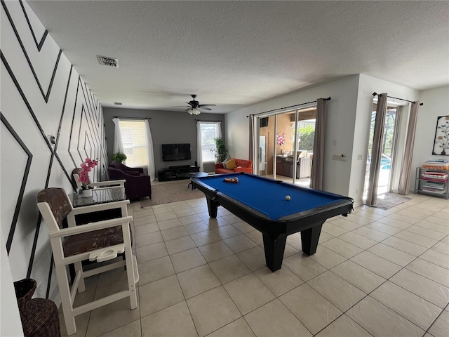 recreation room with a textured ceiling, ceiling fan, light tile patterned flooring, pool table, and visible vents